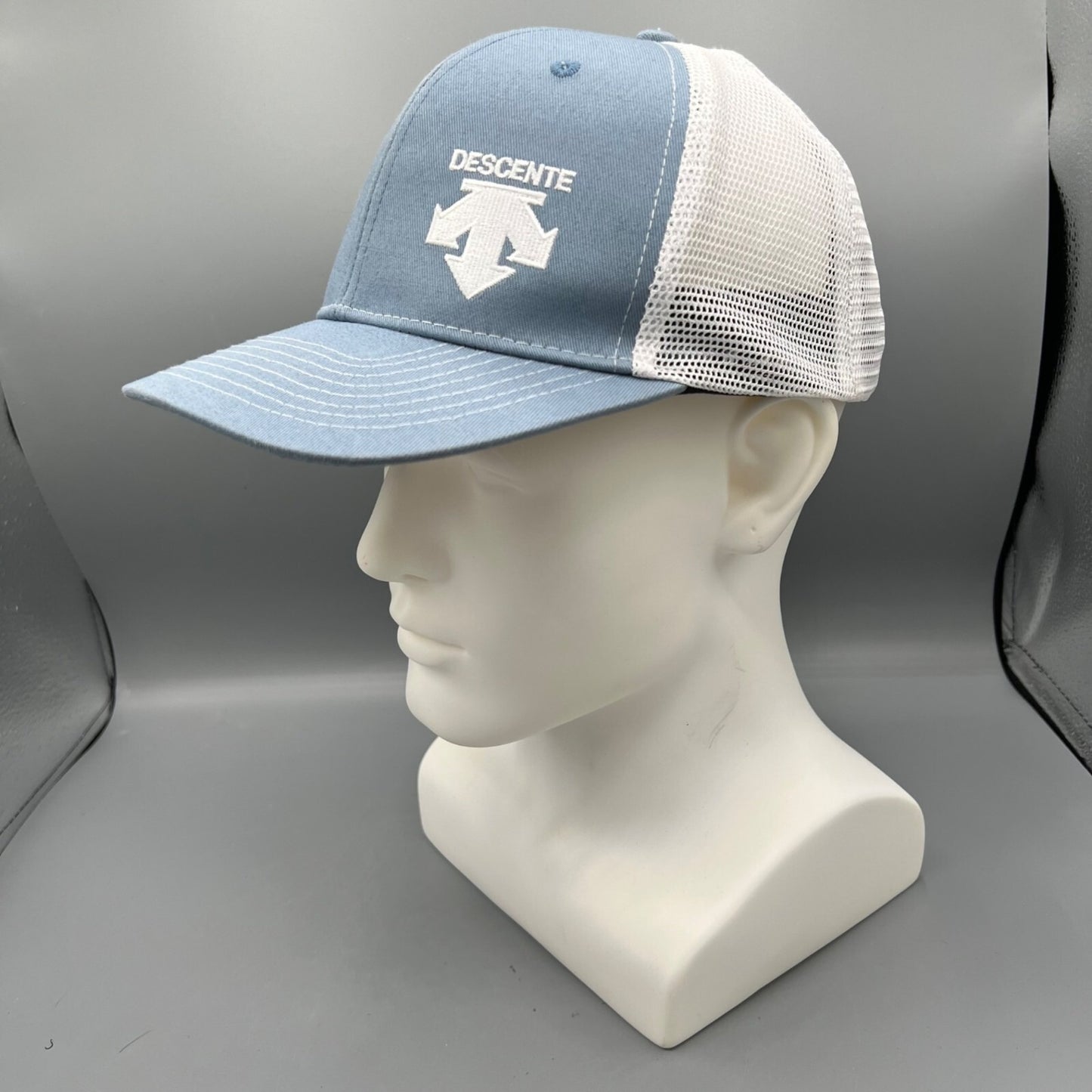 Descente Skiing Mesh Back Six Panel Blue and White Embroidered Logo Trucker Hat