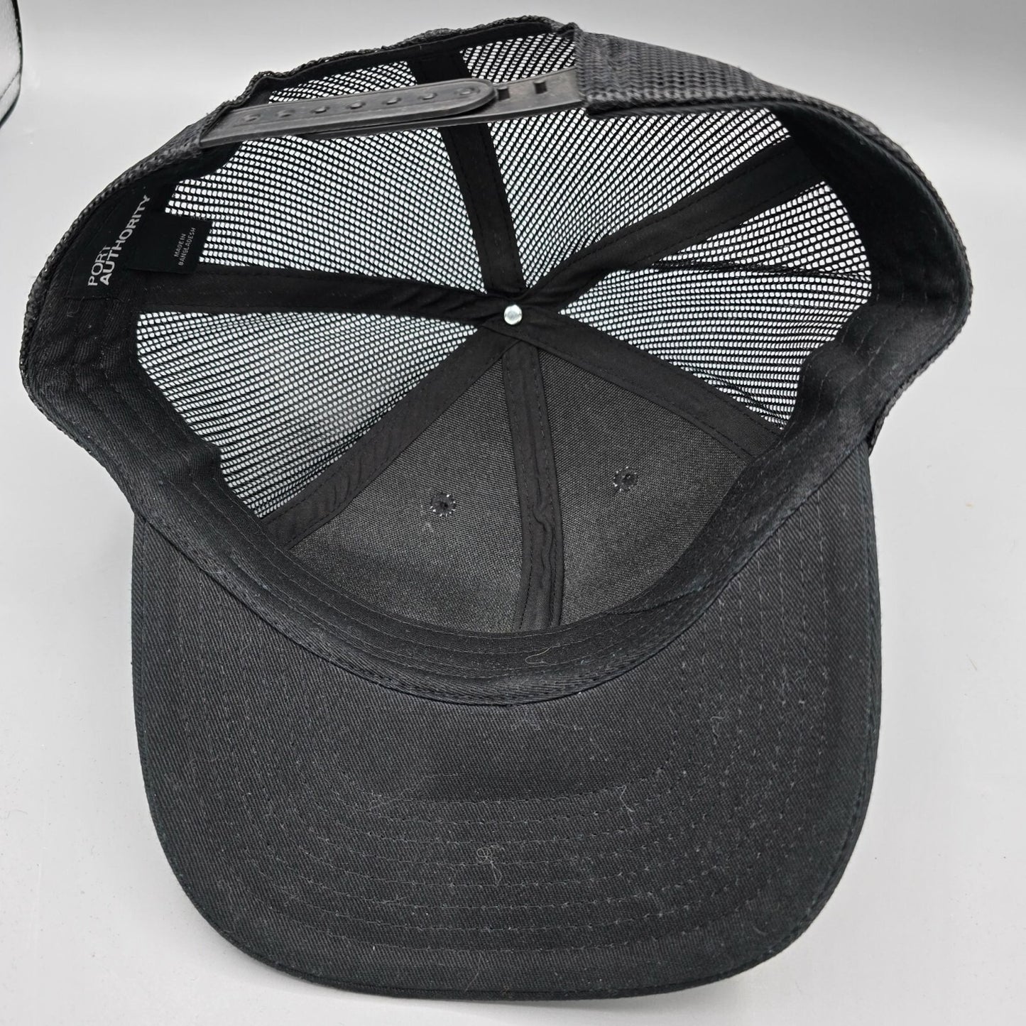 Here Comes The Bridle Port Authority Low-Profile Black Patch Logo Trucker Hat