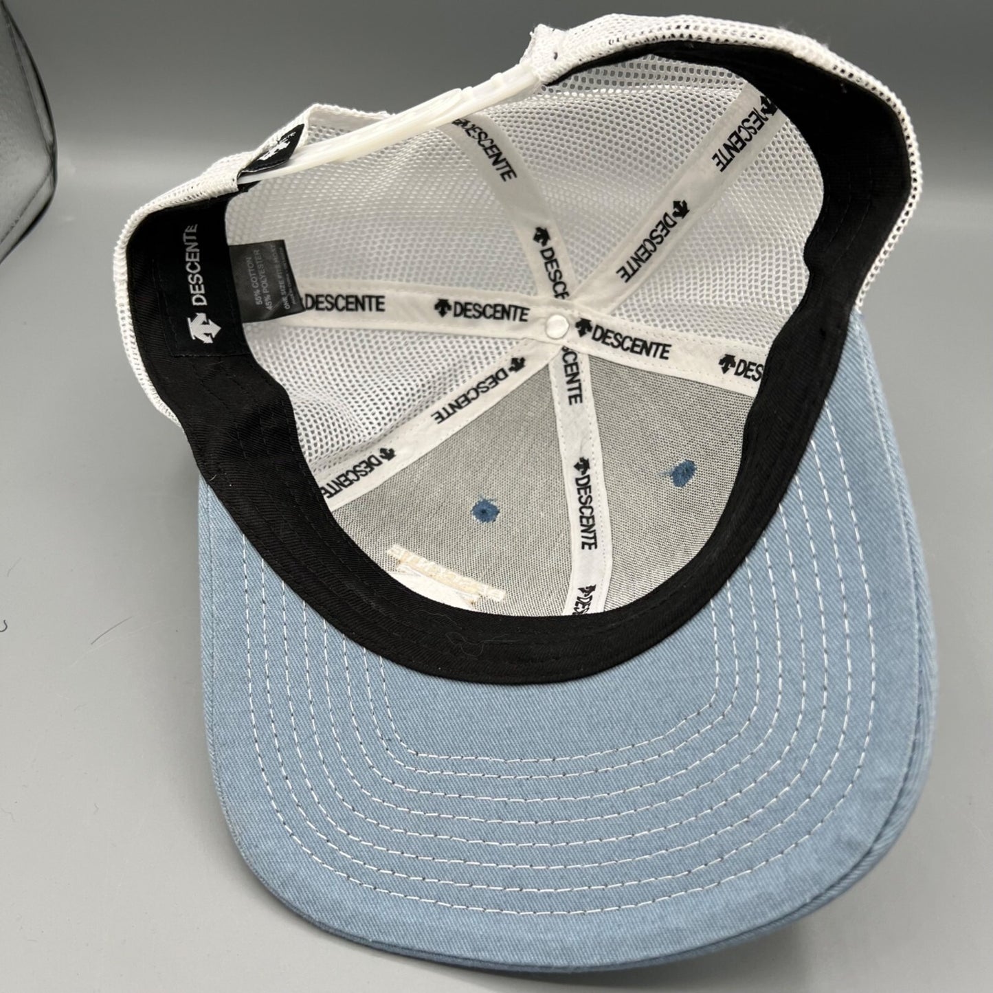 Descente Skiing Mesh Back Six Panel Blue and White Embroidered Logo Trucker Hat