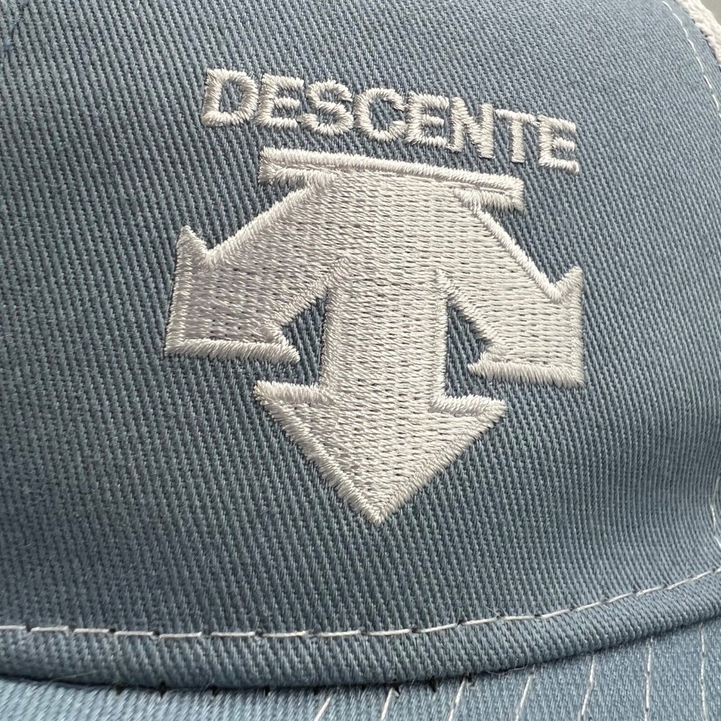 Descente Skiing Mesh Back Six Panel Blue and White Embroidered Logo Trucker Hat